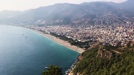 quick pan shot from top of hill with view to the sea and cleopatra beach to the city of alanya and ancient castle.