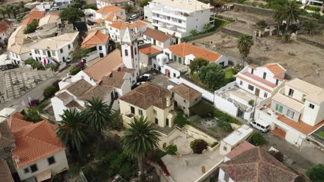 Flying-towards-old-house-of-Christopher-Columbus-in-Vila-Baleira,-aerial