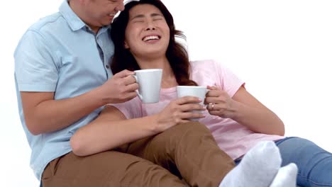 young couple lying and having coffee