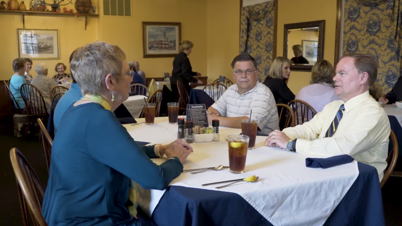 Closeup shot of business people talking while waiting for their food to be delivered at a restaurant.