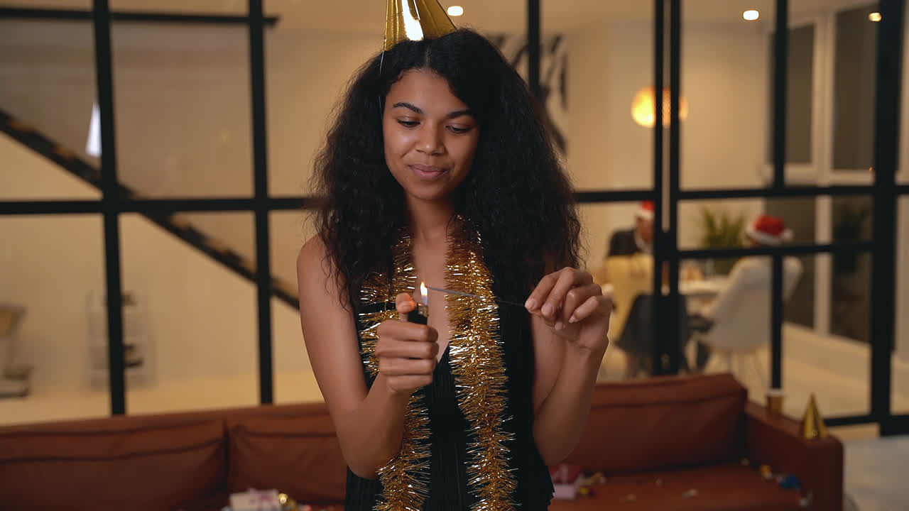 Beautiful Black Woman Lights A Sparkler With A Lighter At New Year's Eve Party