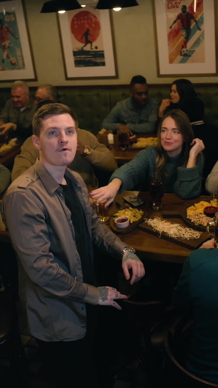 Friends enjoying a meal and drinks at a lively bar