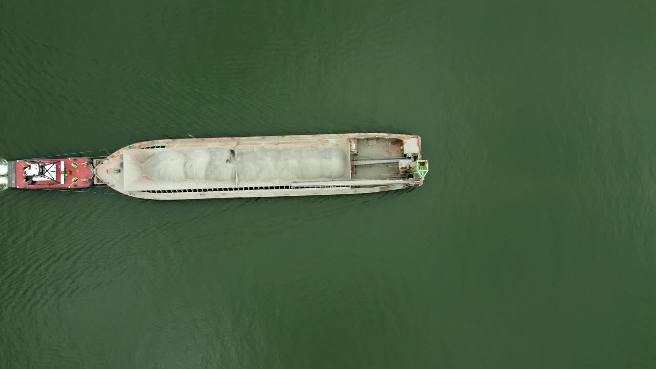 US, Oregon, Portland, St Johns, 2025-07-26 - Drone view of a barge being pushed by a tug on the Willamette River