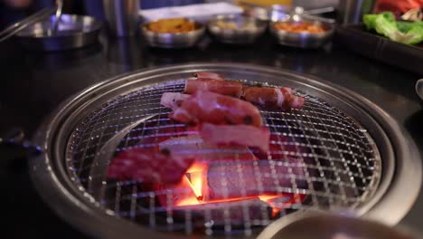 beef and bacon grilling on a restaurant grill