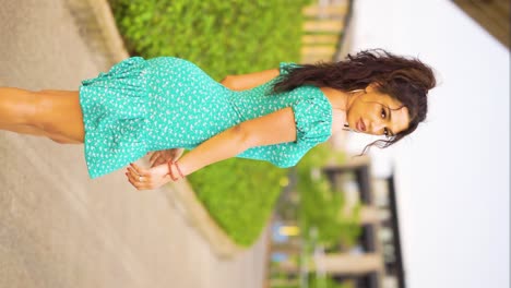 Romanian-Roma-Gipsy-traveller-ethnic-woman-mixed-nationalities-is-walking-away-while-looking-over-the-shoulder-deep-romantic-stare-innocent-stylish-modern-standing-out-model-wearing-cute-dress-outdoor