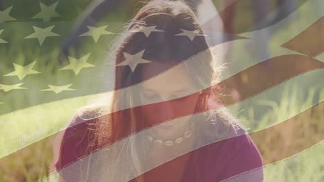 Composite-video-of-american-flag-over-portrait-of-caucasian-female-volunteer-smiling-in-the-forest
