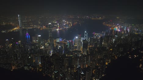 noche iluminada ciudad de hong kong centro de la bahía panorama aéreo 4k china