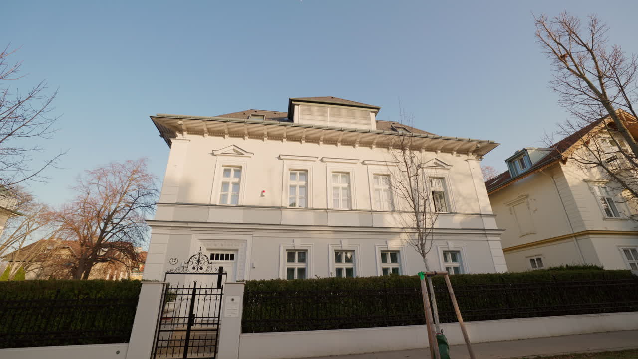 Exterior view of a building with a fence and trees