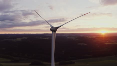 wind turbine at sunset over rural landscape