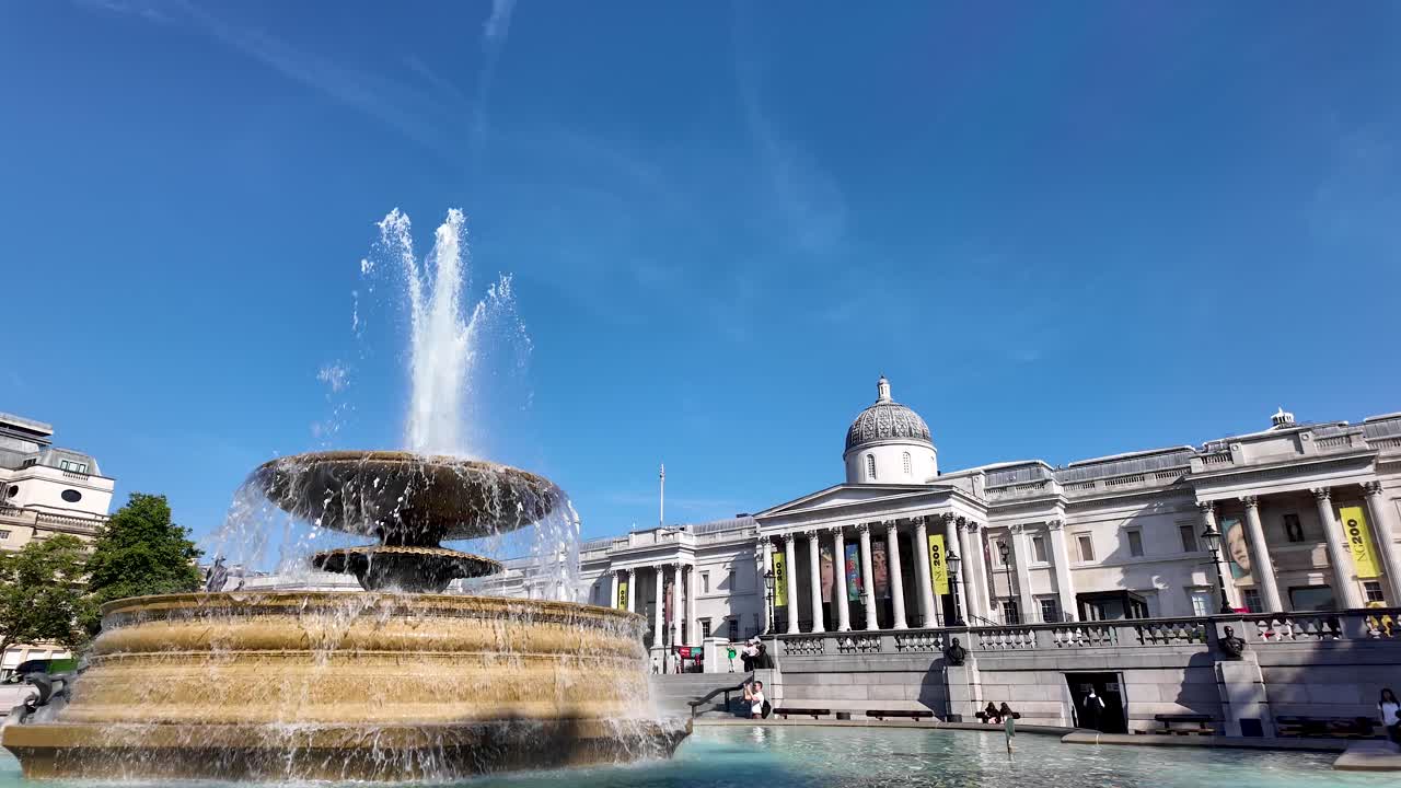 Fountain in Trafalgar Square with the National Gallery in London