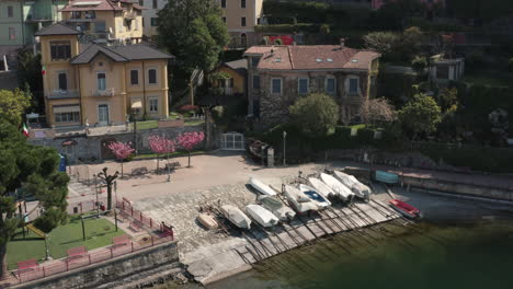 drone view of boats in varenna, on lake como, in italy