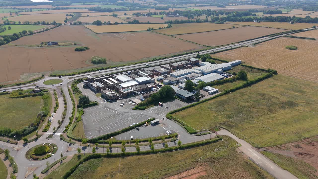 Aerial drone view of motor industry research innovation centre, warehouse business park in England UK