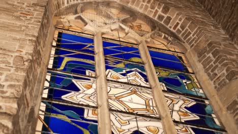 low-angle-view-of-blue-stained-glass-window-inside-a-gothic-church-at-night-time-in-Grolle-the-Netherlands