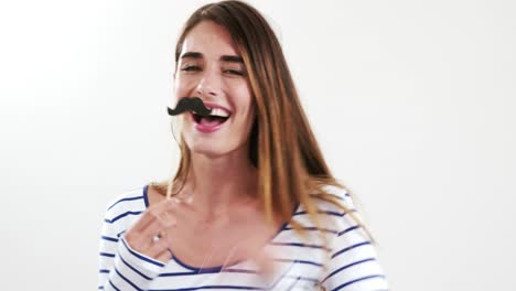 Pretty-brunette-with-fake-mustache-posing-for-camera