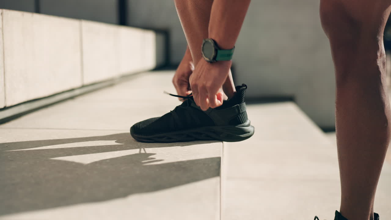 Hands, shoes and tie with an athlete on a step