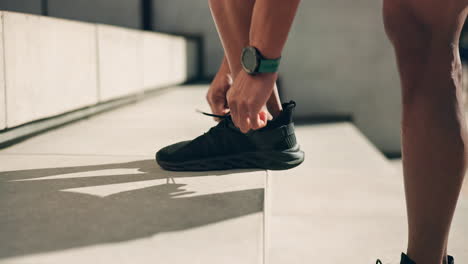 hands, shoes and tie with an athlete on a step