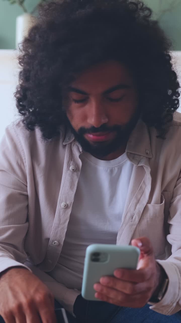 Young man exploring online shopping while sitting at home