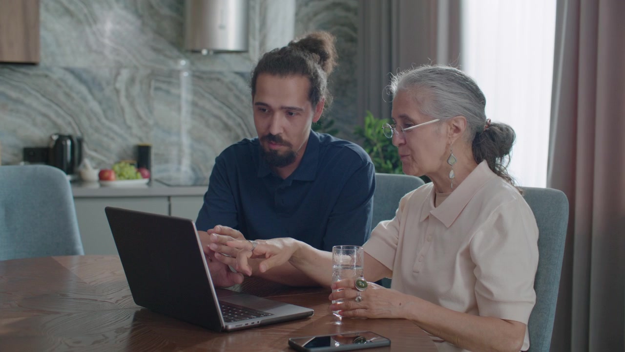 Senior Woman Learning How to Use Laptop from Social Worker at Home