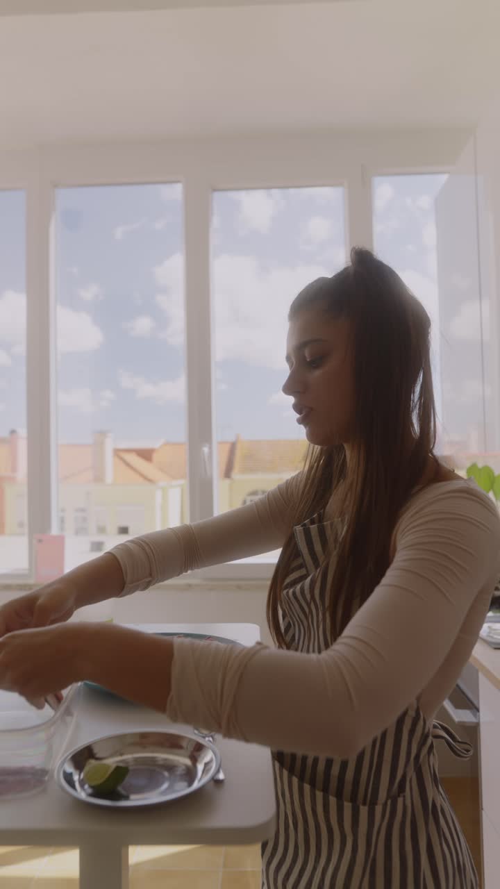 Woman Preparing Seafood Dish in Kitchen