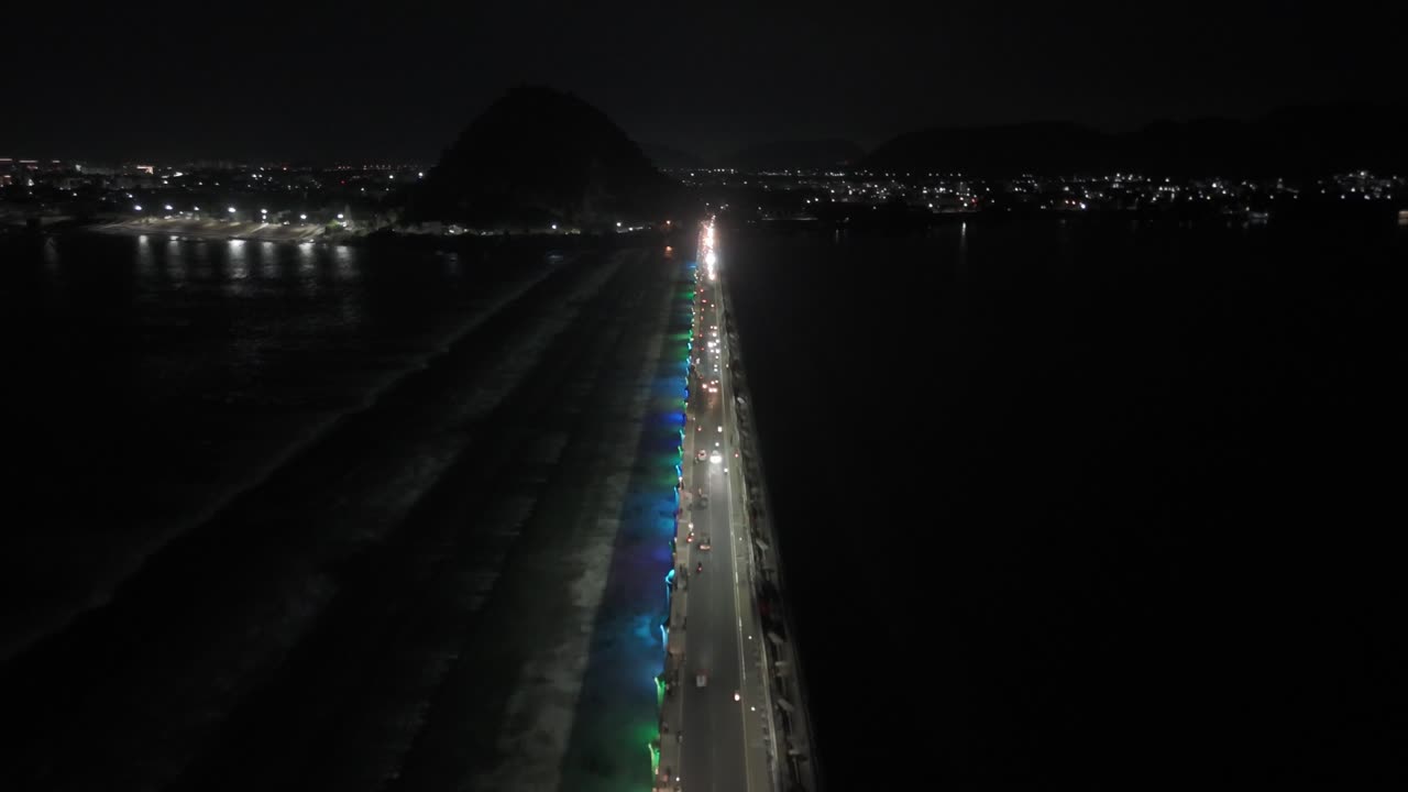 An aerial video of Vijayawada at night, featuring the Prakasam Barrage, would offer a breathtaking panoramic view of the city. illuminated bridge, with its busy road and bustling streets