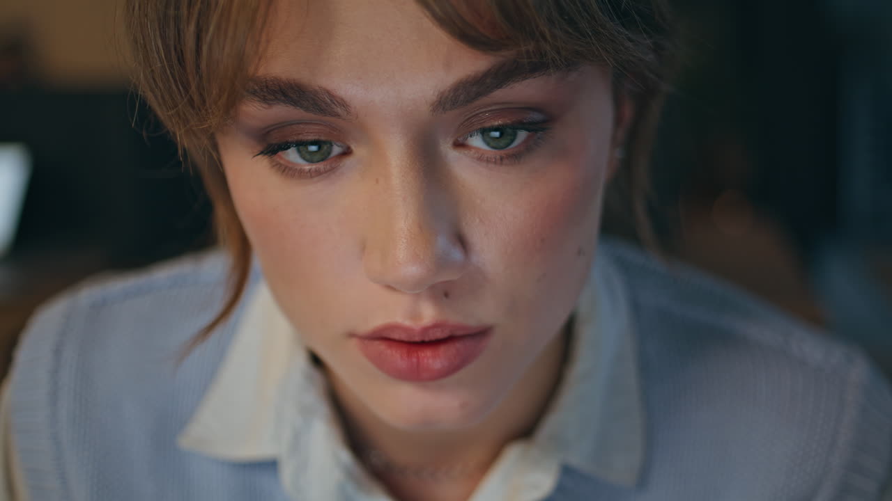 Late worker staring computer at dark interior closeup. Overworked businesswoman