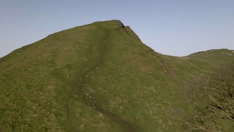 aerial drone footage flying up and over a big hill