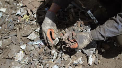 male worker holding scraps in the junkyard 4k