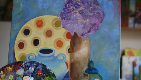 still life painting with palette and flowers