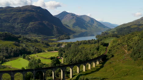 rotating drone shot of famous railroad bridge in the glenfinnan viaduct