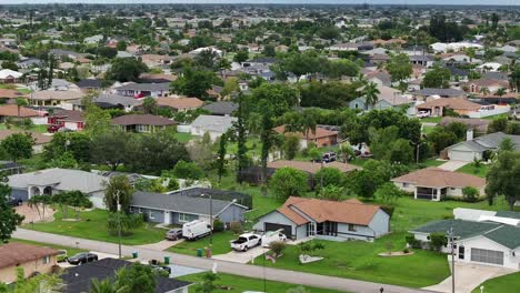 suburban neighborhood in florida featuring one-story homes, driveways, and green lawns