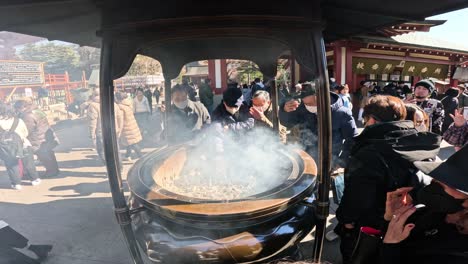 visitors partake in traditional incense burning ceremony.