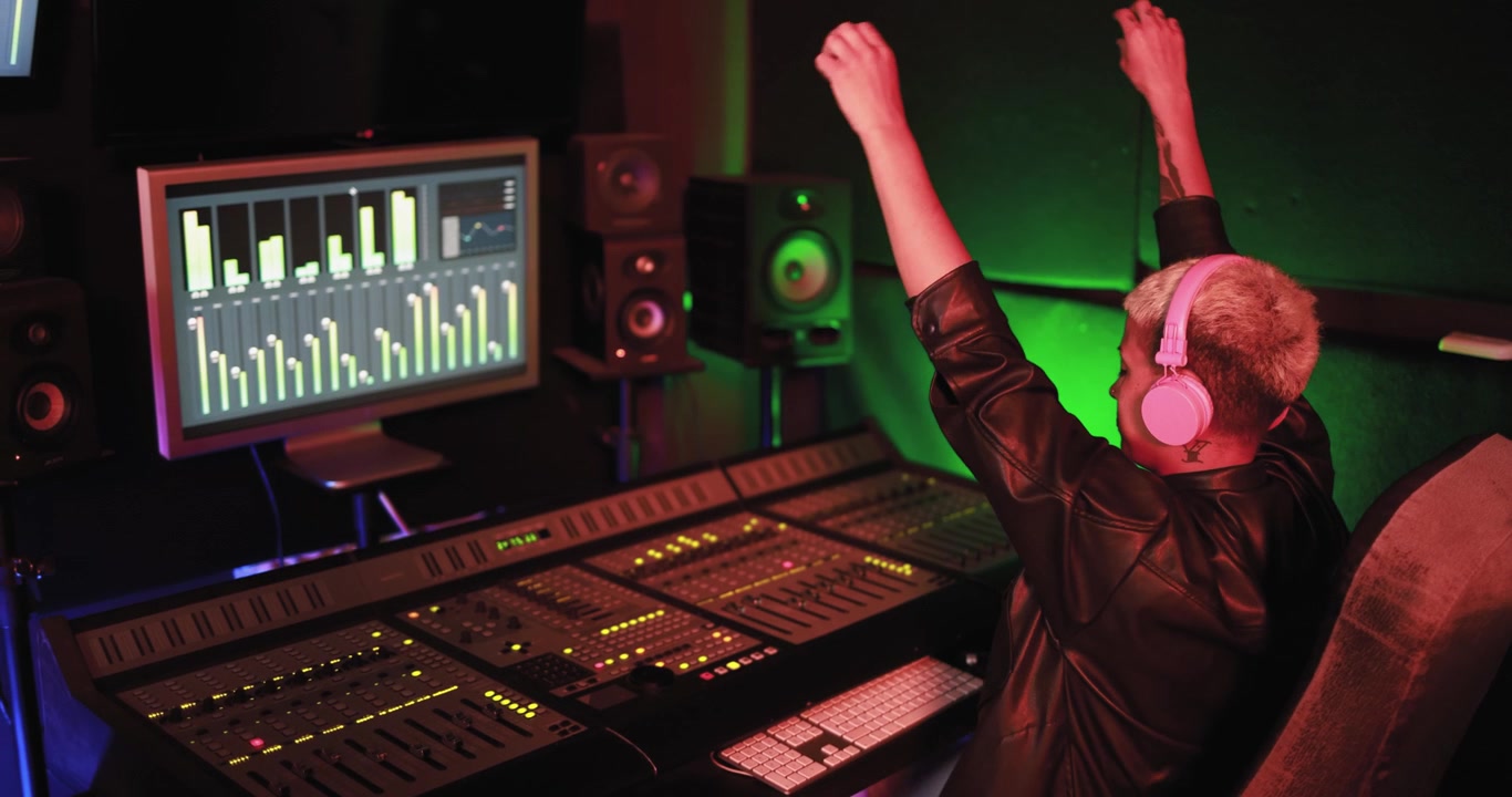 Music Producer with Headphones Celebrating in Recording Studio