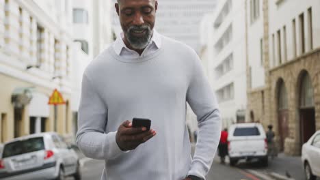 african american man using his phone in the street