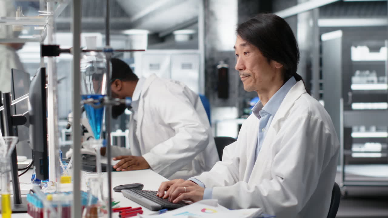 Laboratory Technician Uses Computer App, Doing Research Into Human Health