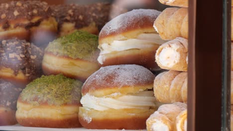 assortment of sweet pastries and donuts in a bakery display