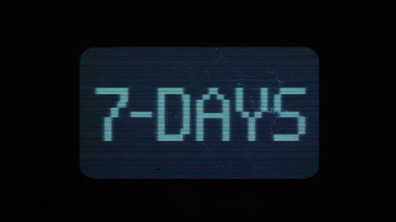 Opening closeup panel showing pixelated cyan 7-DAYS over bluish backdrop, flickering with scanlines