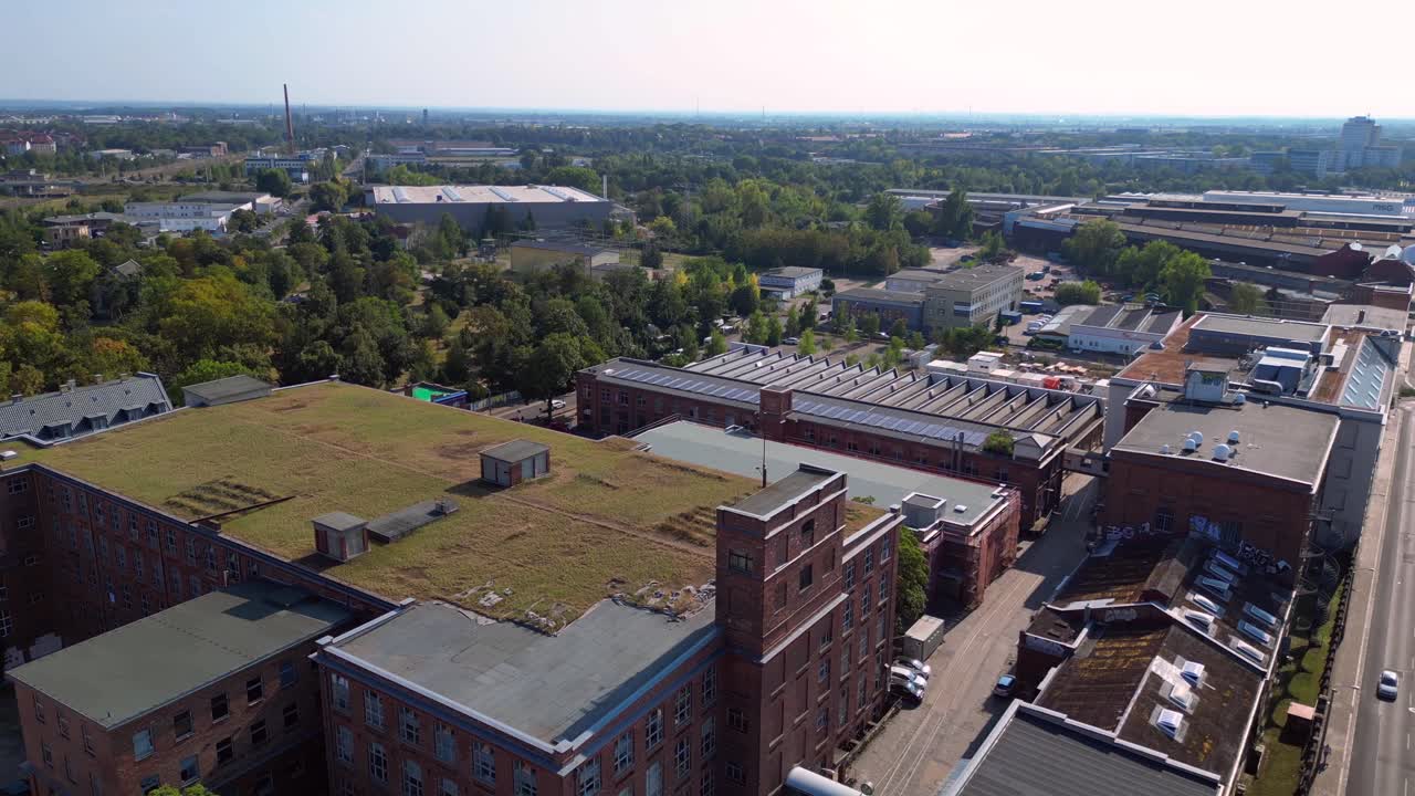 Leipzig cotton spinning mill factory industrial architecture, characterized by brick buildings and a chimney