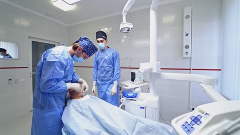 modern dental surgery. dentist surgeon with assistant during dental surgery
