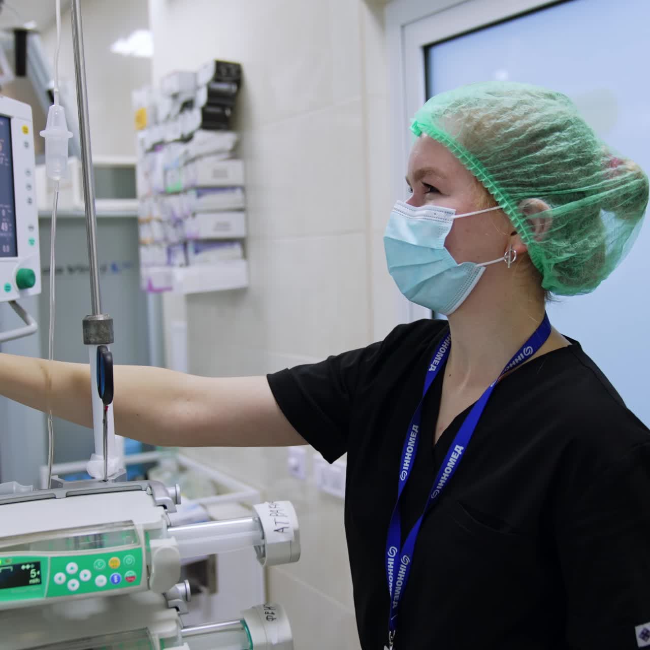 Female nurses working in the surgery room. Medic sets the equipment parameters preparing for the surgery