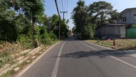 a vehicle's progression along a lush suburban street