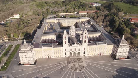 Circling-aerial-of-front-of-Mafra-National-Palace,-Mafra,-Portugal