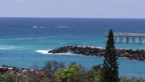 ocean views with sailboats, jetty, and lush greenery