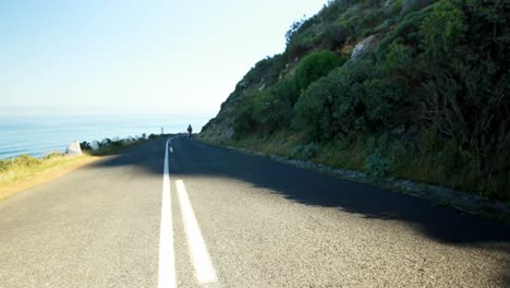 Female-cyclist-cycling-on-a-countryside-road-4k