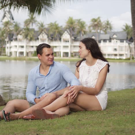 joyful couple tourists spending time on lawn