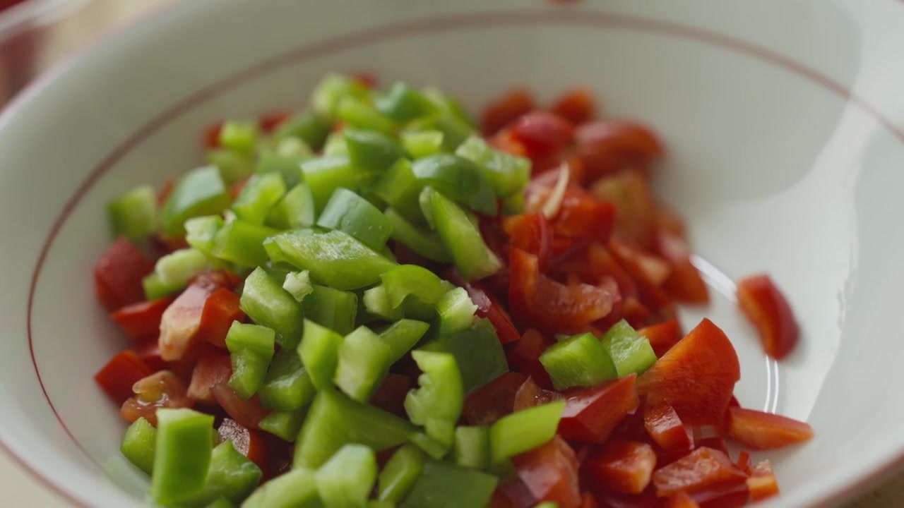 Mixing vegetables in a bowl with a spoon, close-up detail.
Homemade salad preparation in a kitchen environment.