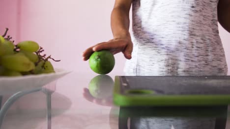 Man rolling mango for salad