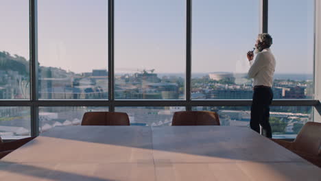 mature african american businessman looking out window planning ahead thinking of ideas for future business development with view of city at sunset 4k