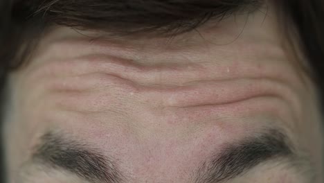 close-up of a human forehead with wrinkles and relaxed skin
