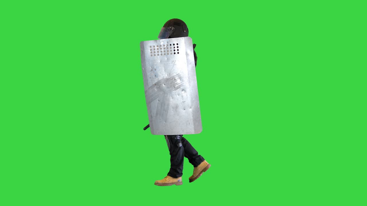 Riot police unit walking with a shield and baton on a Green Screen, Chroma Key