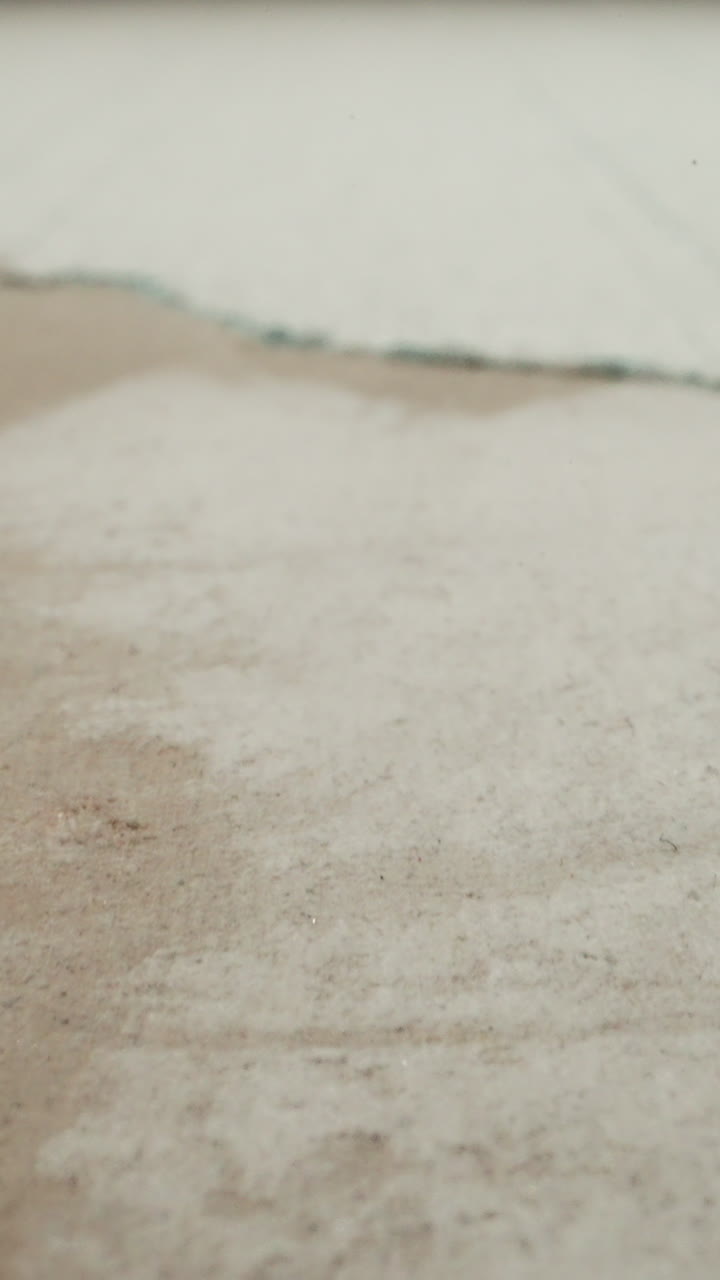 Plasterboard with torn coverage and scratches from cutter in renovated premise macro view. Old building restoration. Repair works and process at home